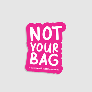 Sticker with 'Not Your Bag' text on a pink background. Designed to go on suitcases.
