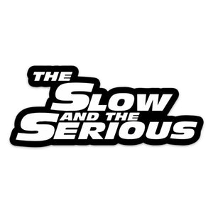 A sticker with the text 'THE SLOW AND THE SERIOUS' in bold, black and white letters.
