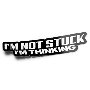 A black vinyl sticker with white text saying 'I'M NOT STUCK I'M THINKING'.