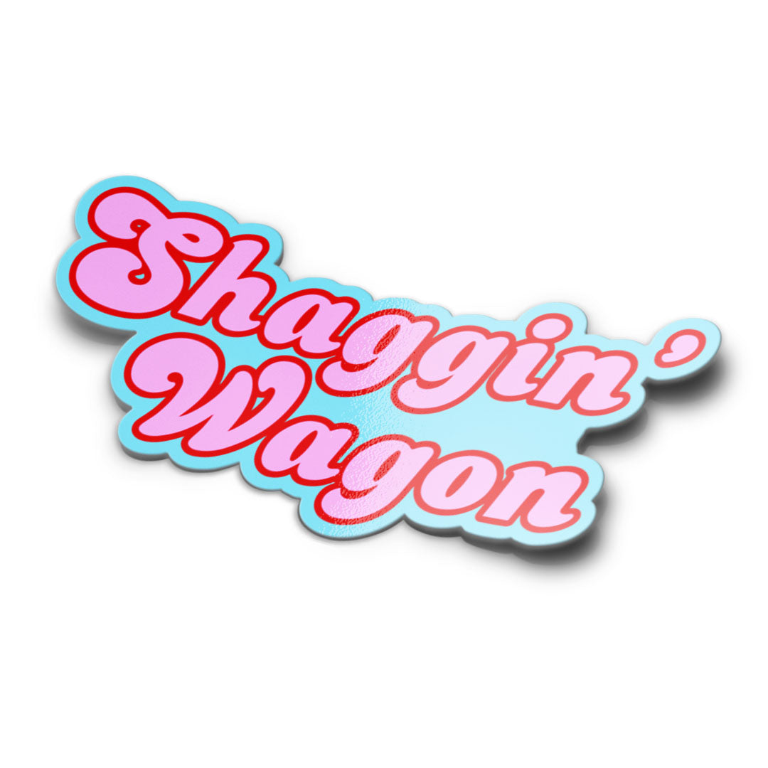 A mockup of a bumper sticker with the text 'Shaggin' Wagon' in a playful, bold font with a blue and pink colour scheme.