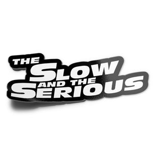 A sticker with the text 'THE SLOW AND THE SERIOUS' in bold, black and white letters.