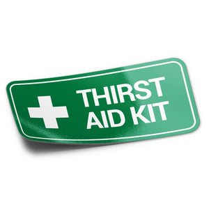 A green sticker with the text 'THIRST AID KIT' and a white cross symbol on it.