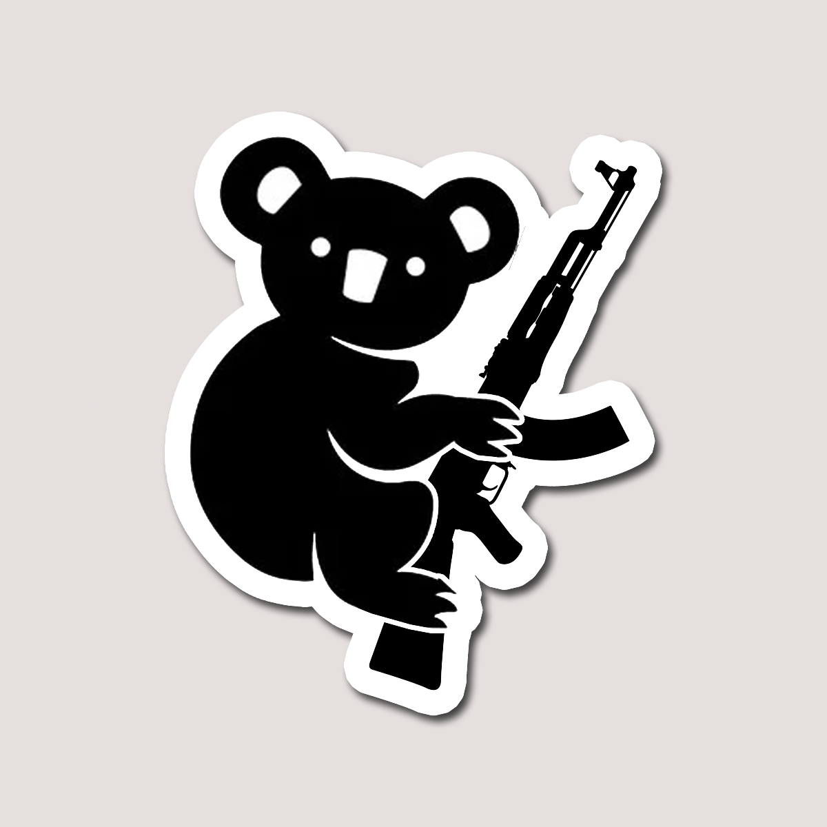 A sticker depicting a cartoon koala holding a gun. Black and white colouring.