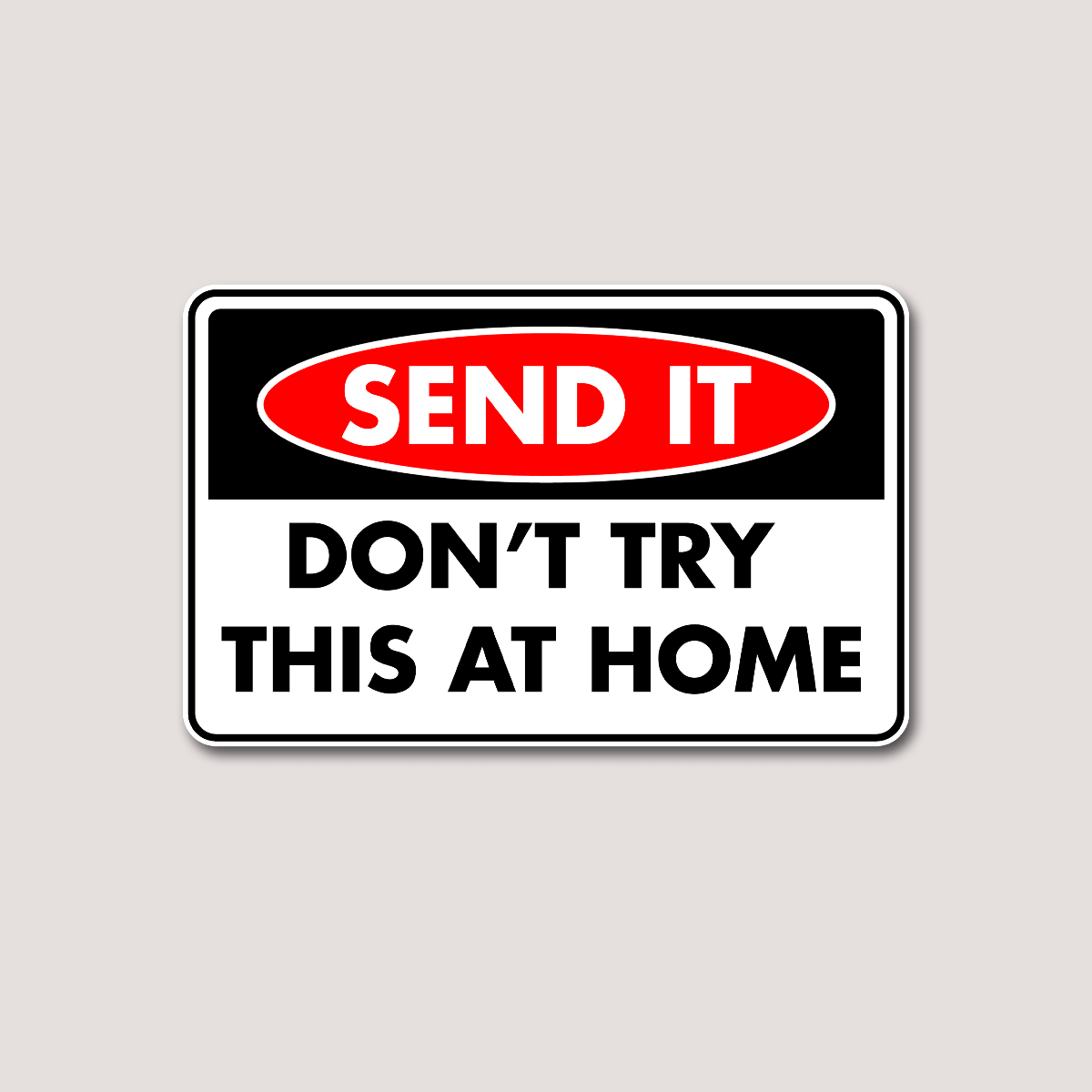 A sticker with a black and red background featuring the text 'SEND IT DON'T TRY THIS AT HOME' in white letters.