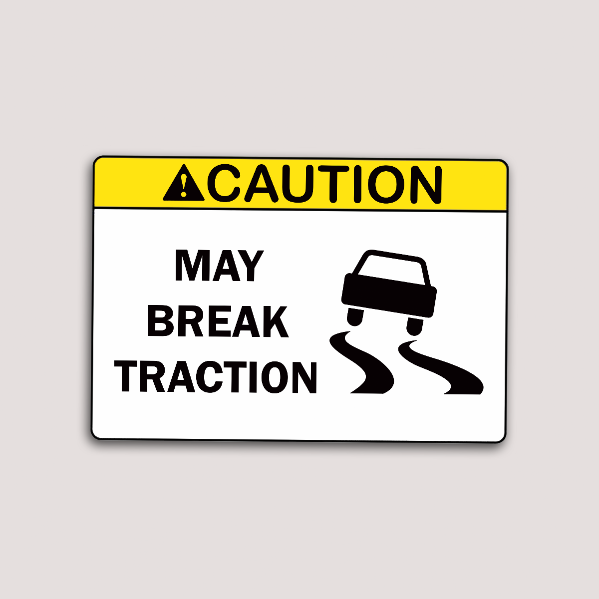 A sticker with a caution sign that warns 'MAY BREAK TRACTION' with an illustration of a car skidding to the side.