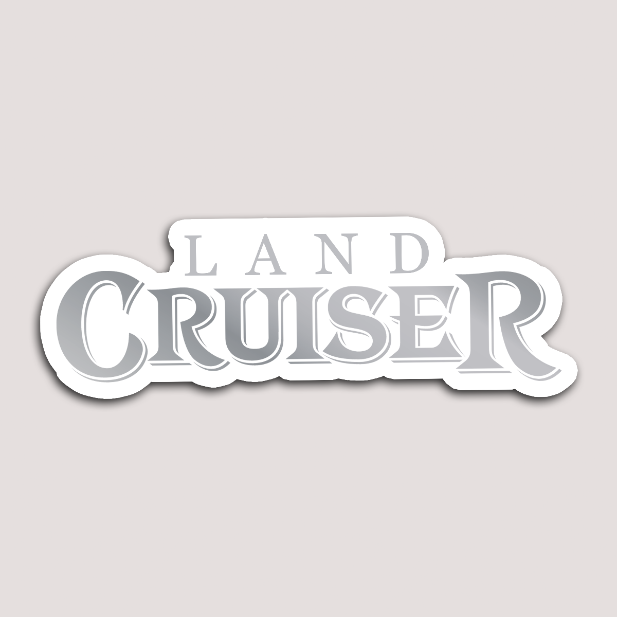 A sticker with the text 'LAND CRUISER' in bold, capital letters with a white background.