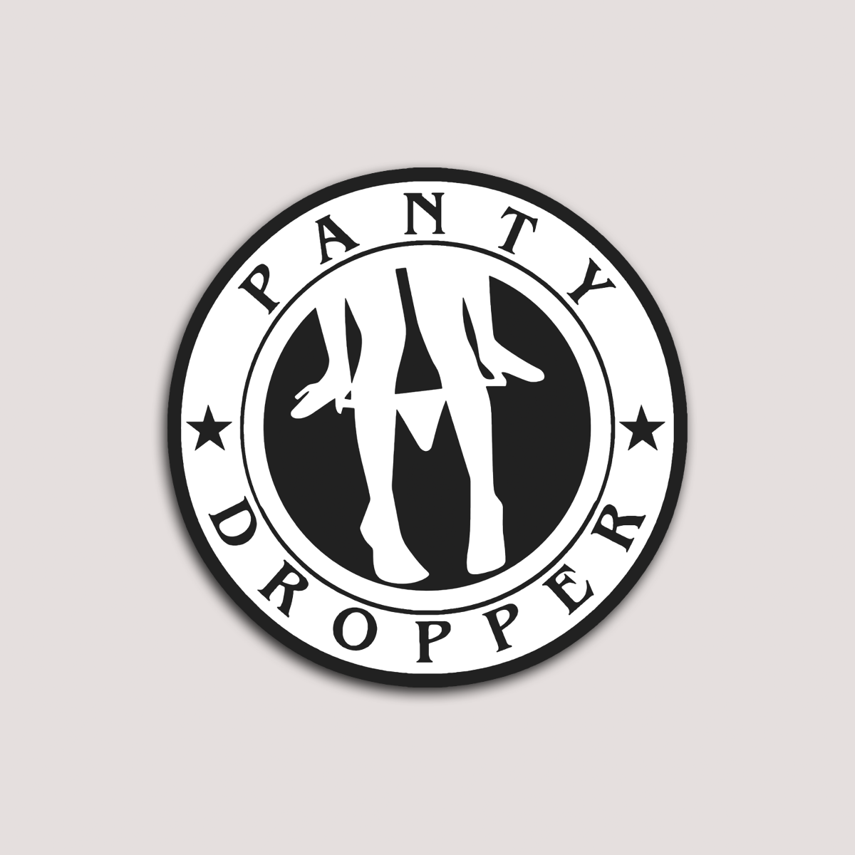 This image features the "Panty Dropper Emblem Sticker," a playful and striking vinyl sticker. The sticker displays a bold, black and white graphic of a silhouette of a woman with the phrase "Panty Dropper" encircled around it, creating a bold visual impact.