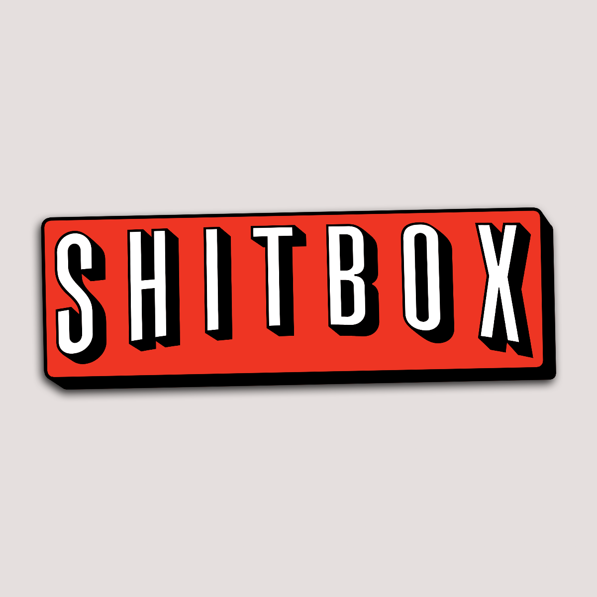 A red sticker with the word 'SHITBOX' written in white, bold, capital letters against a white background.